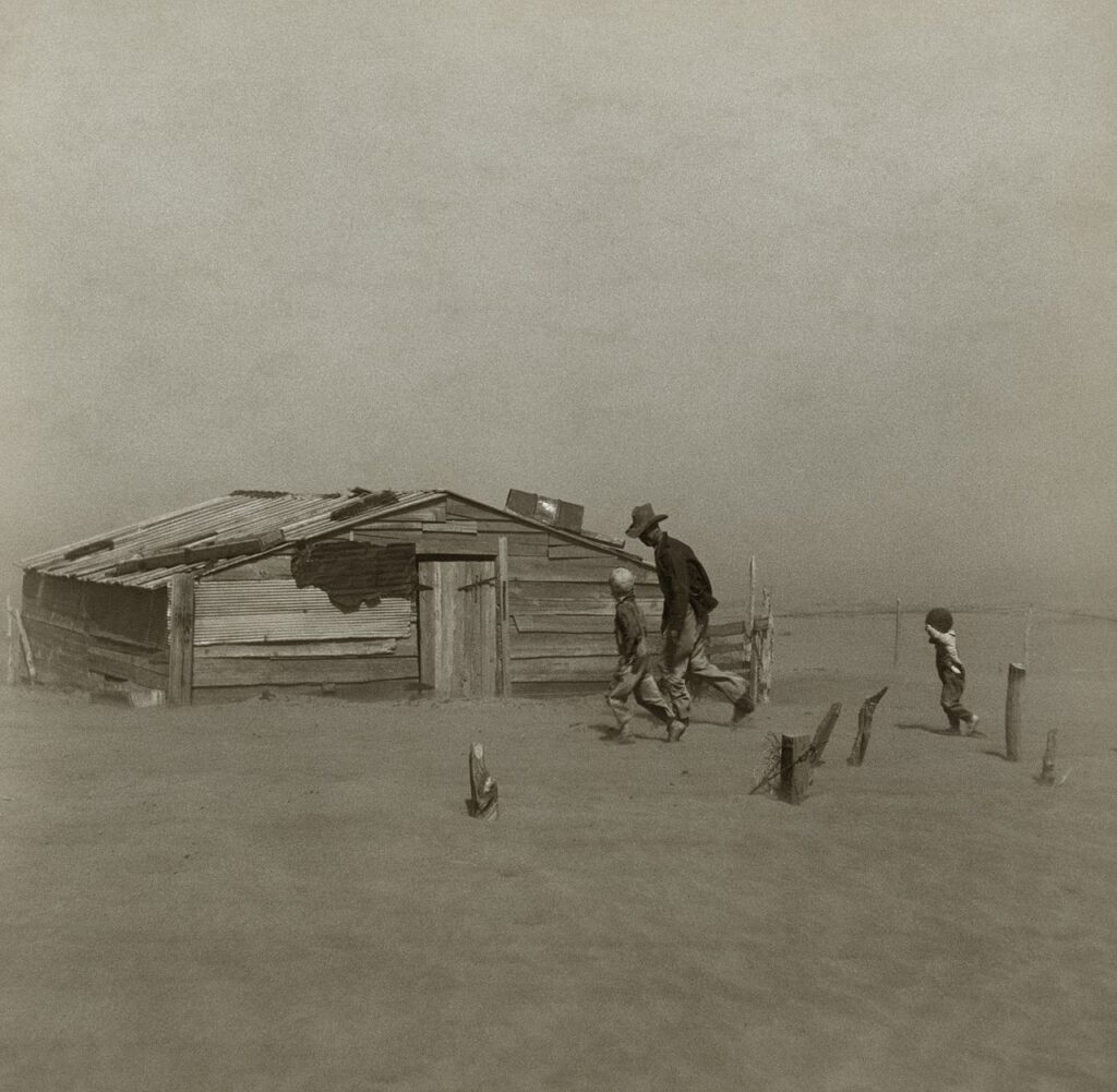 Farmer walking in dust storm in Cimarron County, Oklahoma