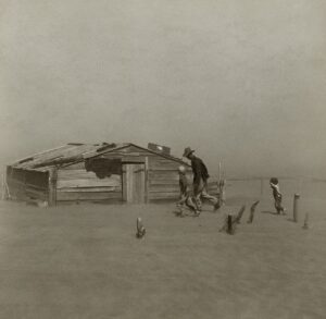 Farmer walking in dust storm in Cimarron County, Oklahoma